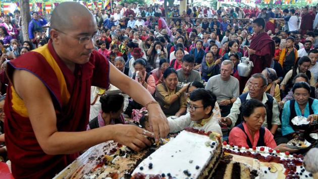 An exiled Tibetan Buddhist monk distributes birthday cake on the 82nd birthday of their spiritual leader the Dalai Lama in Mcleodganj, near Dharamsala on Thursday. (Shyam Sharma/HT Photo) 