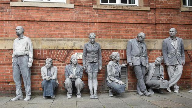 Performers smeared with clay rest during the art action ‘1000 Gestalten’ on a street in Hamburg, northern Germany, where leaders of the world's top economies will gather for a G20 summit. (Christof Stache / AFP)