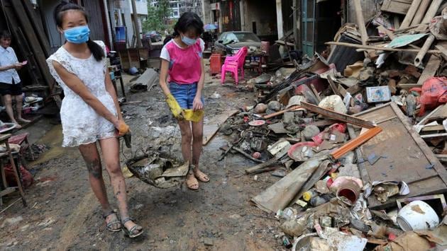 People remove items from mud after the flood at Qiaotouhe town in Lianyuan, Hunan province. (REUTERS) People remove items from mud after the flood at Qiaotouhe town in Lianyuan, Hunan province. (REUTERS)