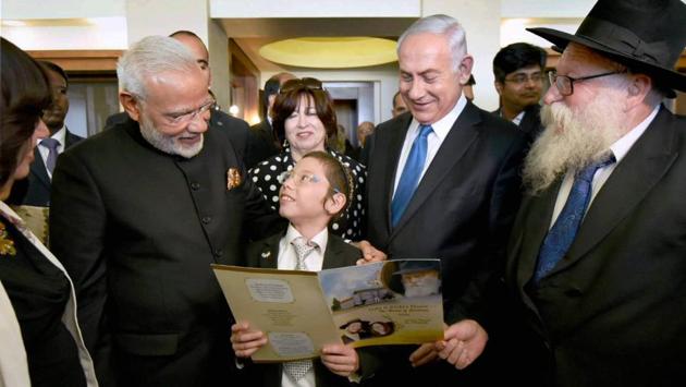 Prime Minister Narendra Modi, flanked by  Benjamin Netanyahu  (2nd R) also met with the 11-year-old Moshe Holtzberg, one of the survivors of the 26/11 Mumbai terror attacks, at the Kind David Hotel in Jerusalem, Israel. (PTI) 