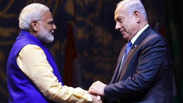 Prime Minister Narendra Modi shakes hands with Israeli Prime Minister Benjamin Netanyahu at the Community Reception Programme in Tel Aviv. (PTI Photo) Prime Minister Narendra Modi shakes hands with Israeli Prime Minister Benjamin Netanyahu at the Community Reception Programme in Tel Aviv. (PTI Photo)