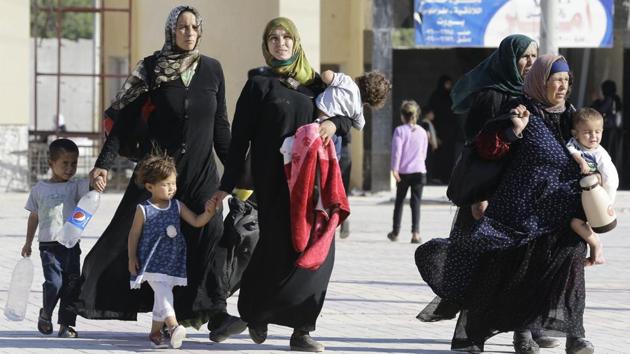 Displaced Syrians who fled with their families Islamic State controlled areas in Raqa, Deir Ezzor and Mayadeen gather at Aleppo's bus station of Ramussa on July 4, 2017. (AFP) Displaced Syrians who fled with their families Islamic State controlled areas in Raqa, Deir Ezzor and Mayadeen gather at Aleppo's bus station of Ramussa on July 4, 2017. (AFP)