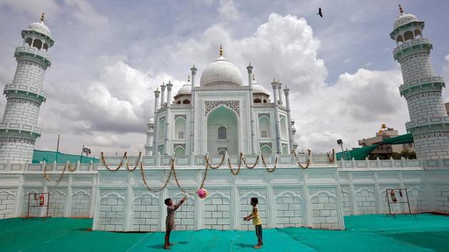 Children play with a ball in front of a replica of the Taj Mahal built at a fair ground in Bengaluru. (REUTERS) Children play with a ball in front of a replica of the Taj Mahal built at a fair ground in Bengaluru. (REUTERS)