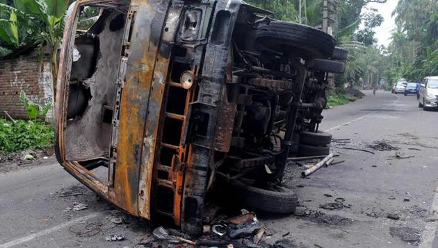 A burnt vehicle seen at a road after a communal riot at Baduria in North 24 Pargana district of West Bengal on Wednesday.(PTI Photo)