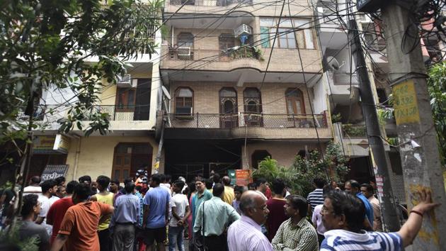 Local residents gather outside the building in Dilshad Colony where the incident took place on Friday. (Ravi Choudhary/HT PHOTO) Local residents gather outside the building in Dilshad Colony where the incident took place on Friday. (Ravi Choudhary/HT PHOTO)
