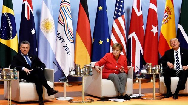 Argentinia's President Mauricio Macri, German chancellor Angela Merkel and US President Donald Trump at the start of the retreat meeting on the first day of the G20 summit in Hamburg, Germany.(Reuters Photo) Argentinia's President Mauricio Macri, German chancellor Angela Merkel and US President Donald Trump at the start of the retreat meeting on the first day of the G20 summit in Hamburg, Germany.(Reuters Photo)