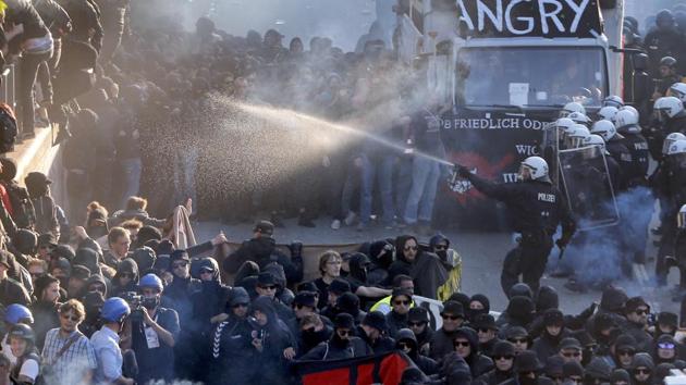 A police officer sprays water canons during a protest against the G20 summit in Hamburg, northern Germany on Thursday. (AP Photo)