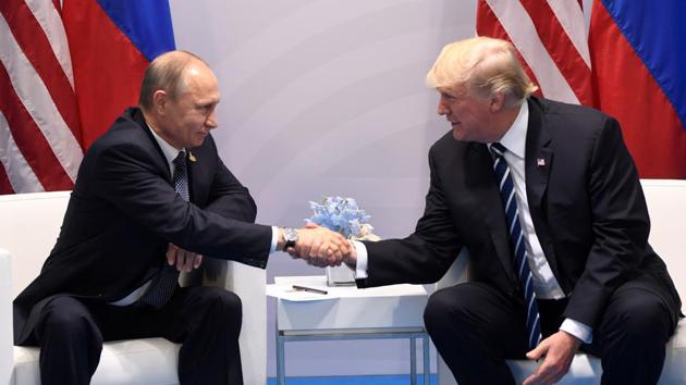 US President Donald Trump and Russia's President Vladimir Putin shake hands during a meeting on the sidelines of the G20 Summit in Hamburg, Germany.(AFP Photo)