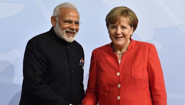 German Chancellor Angela Merkel and Prime Minister Narendra Modi greet each other during the first day of the G20 summit in Hamburg. (AP)