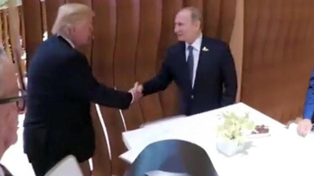 In this image taken from video US President Donald Trump shakes hand with the Russian President Vladimir Putin during the G20 summit in Hamburg, Germany, on Friday. (AP) In this image taken from video US President Donald Trump shakes hand with the Russian President Vladimir Putin during the G20 summit in Hamburg, Germany, on Friday. (AP)