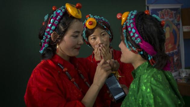 Exiled Tibetans women in their traditional dress prepare for a dance performance during celebrations marking the 82nd birthday of their spiritual leader the Dalai Lama at a Tibetan settlement in New Delhi, India. (AP) Exiled Tibetans women in their traditional dress prepare for a dance performance during celebrations marking the 82nd birthday of their spiritual leader the Dalai Lama at a Tibetan settlement in New Delhi, India. (AP)