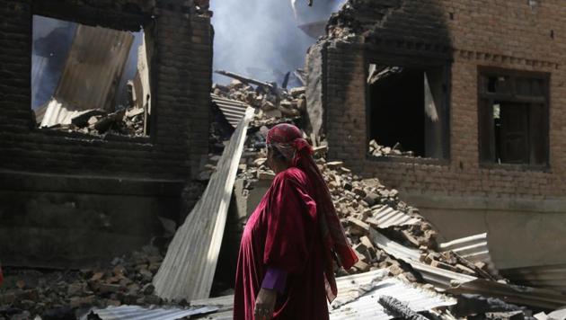 A Kashmiri woman looks at the debris of one of the damaged houses after a gunbattle at Bahmnoo village 58 kilometers (36 miles) south of Srinagar. Government forces killed three rebels in a gunbattle in the Kashmir while 35 civilians were injured in anti-India protests and clashes in solidarity with militants, police and witnesses said. (AP) A Kashmiri woman looks at the debris of one of the damaged houses after a gunbattle at Bahmnoo village 58 kilometers (36 miles) south of Srinagar. Government forces killed three rebels in a gunbattle in the Kashmir while 35 civilians were injured in anti-India protests and clashes in solidarity with militants, police and witnesses said. (AP)