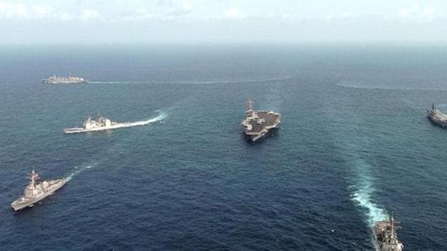 Ships assigned to the USS Nimitz(C) Carrier Strike Group and the Indian aircraft carrier Viraat(2nd-R) underway in the Indian Ocean 25 September, 2005 in formation as part of exercise ‘Malabar 2005’.(AFP File Photo)