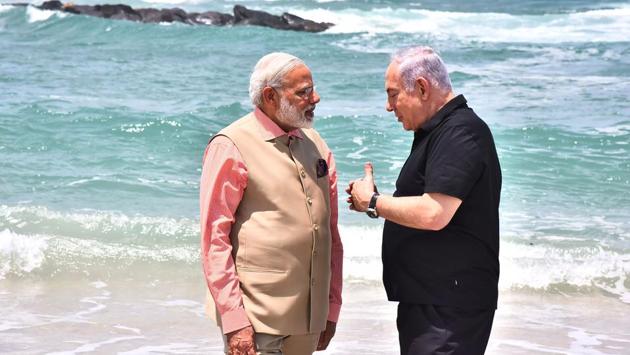 Modi and Netanyahu seen standing ankle deep in the waters with waves lapping at their feet, engaged in what seemed like an intense discussion. (AFP) Modi and Netanyahu seen standing ankle deep in the waters with waves lapping at their feet, engaged in what seemed like an intense discussion. (AFP)