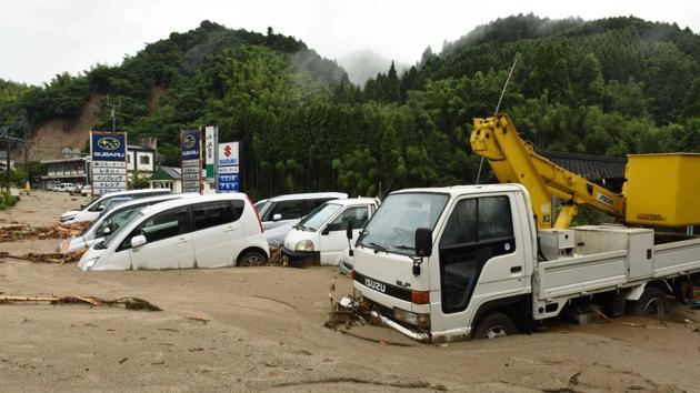 Vehicles are buried in the mud following heavy flooding in Asakura, Fukuoka prefecture. (AFP Photo) Vehicles are buried in the mud following heavy flooding in Asakura, Fukuoka prefecture. (AFP Photo)