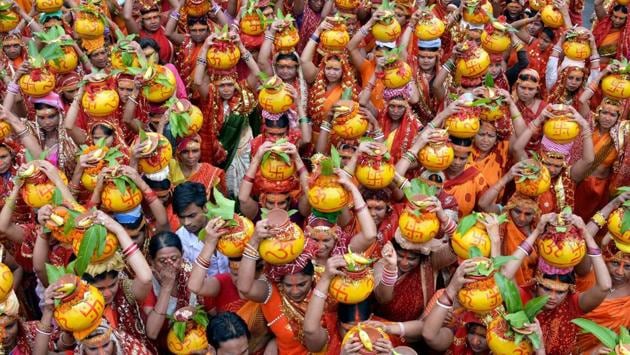 Devotee carryi pitchers during holy Kalash Yatra on the eve of Sawan festival in Patna. (PTI) Devotee carryi pitchers during holy Kalash Yatra on the eve of Sawan festival in Patna. (PTI)