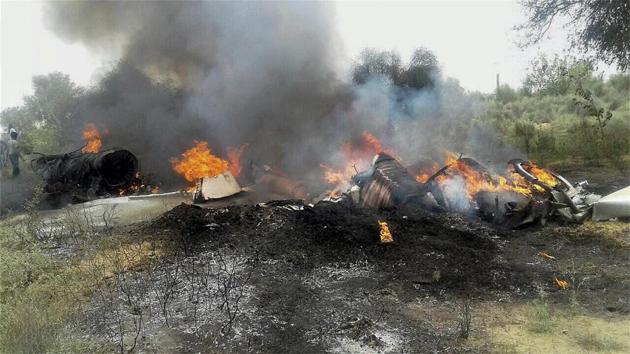 People watch the burning wreckage of MiG-23 trainer aircraft of the Indian Air Force after it crashed in the Balesar near Jodhpur. Both pilots of the aircraft ejected safely. (PTI) People watch the burning wreckage of MiG-23 trainer aircraft of the Indian Air Force after it crashed in the Balesar near Jodhpur. Both pilots of the aircraft ejected safely. (PTI)