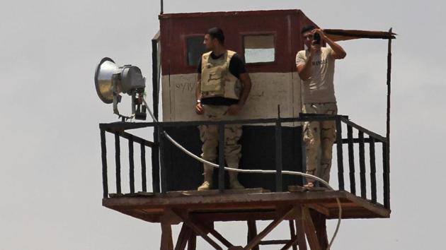 Members of the Egyptian security forces stand guard near the border with Egypt, in Rafah in the southern Gaza Strip on July 6, 2017. (AFP)