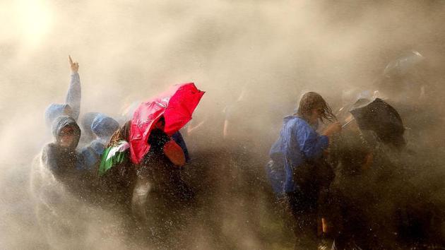 Demonstrators are hit by water cannons of the police as they protest against the ongoing G20 summit. (AFP) Demonstrators are hit by water cannons of the police as they protest against the ongoing G20 summit. (AFP)