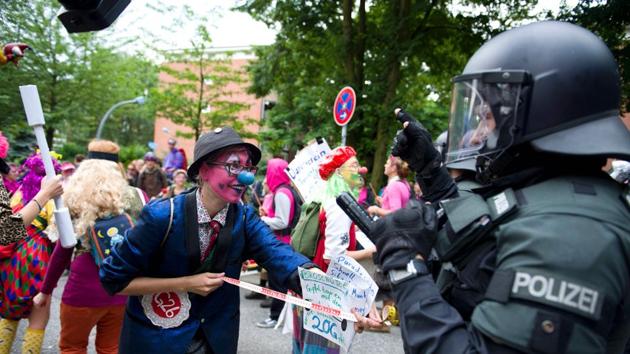 Demonstrators dressed as clowns face policemen as they take part in a protest. Most protesters expressed their opposition to the summit in peaceful ways asking for quick action on climate change and solutions to the migration crisis. (AFP) Demonstrators dressed as clowns face policemen as they take part in a protest. Most protesters expressed their opposition to the summit in peaceful ways asking for quick action on climate change and solutions to the migration crisis. (AFP)