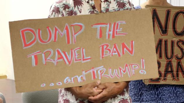 FILE- In this June 30, 2017, file photo, critics of President Donald Trump's travel ban hold signs during a news conference with Hawaii Attorney General Douglas Chin in Honolulu. A federal judge in Hawaii on Thursday, July 6, left Trump administration rules in place for a travel ban on citizens from six majority-Muslim countries. (AP) FILE- In this June 30, 2017, file photo, critics of President Donald Trump's travel ban hold signs during a news conference with Hawaii Attorney General Douglas Chin in Honolulu. A federal judge in Hawaii on Thursday, July 6, left Trump administration rules in place for a travel ban on citizens from six majority-Muslim countries. (AP)