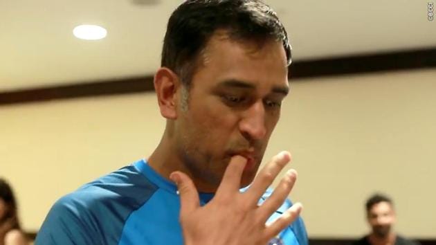 Birthday boy MS Dhoni gets a taste of his cake before cutting it.  (BCCI) 