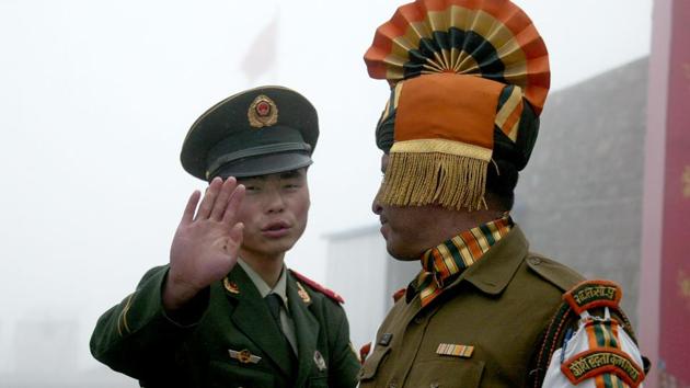 This file photo shows a Chinese soldier next to an Indian soldier at the Nathu La border crossing between India and China in Sikkim. (AFP File Photo) This file photo shows a Chinese soldier next to an Indian soldier at the Nathu La border crossing between India and China in Sikkim. (AFP File Photo)