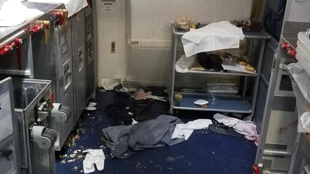 This photo released via the US Attorney's Office in Seattle shows the aftermath of a cabin on Delta Flight 129 from Seattle to Beijing, after authorities say flight attendants struggled with Joseph Daniel Hudek IV, a passenger who lunged for an exit door. (AP Photo) This photo released via the US Attorney's Office in Seattle shows the aftermath of a cabin on Delta Flight 129 from Seattle to Beijing, after authorities say flight attendants struggled with Joseph Daniel Hudek IV, a passenger who lunged for an exit door. (AP Photo)