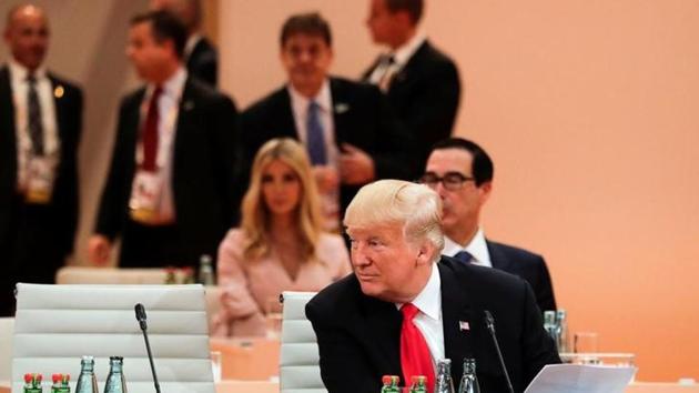 US President Donald Trump sits in front of his delegation with daughter Ivanka Trump (background centre) at the G20 summit in Hamburg, Germany, on Saturday.(Reuters photo) US President Donald Trump sits in front of his delegation with daughter Ivanka Trump (background centre) at the G20 summit in Hamburg, Germany, on Saturday.(Reuters photo)