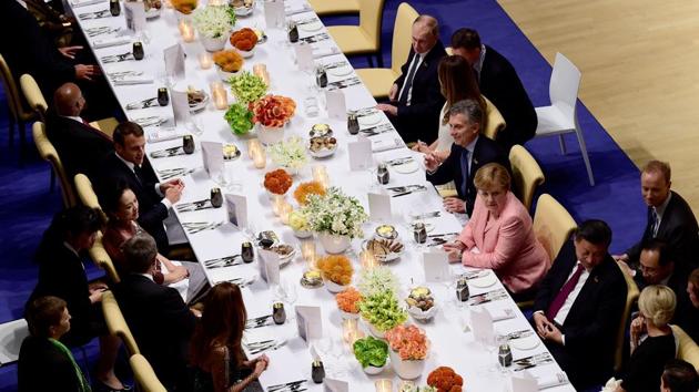 (L-R) Russia's President Vladimir Putin, US First Lady Melania Trump, Argentina's President Mauricio Macri, German Chancellor Angela Merkel, China's President Xi Jinping, wife of French President Brigitte Trogneux attend the banquet after a concert at the Elbphilharmonie hall during the G20 Summit. (AFP)