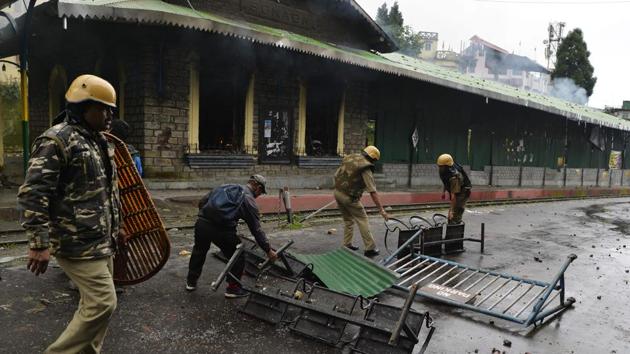 Policemen remove a barricade near the train station set alight during clashes with Gorkhaland supporters during an indefinite strike called Gorkha Janamukti Morcha (GJM), in Sonada near Darjeeling. (AFP) Policemen remove a barricade near the train station set alight during clashes with Gorkhaland supporters during an indefinite strike called Gorkha Janamukti Morcha (GJM), in Sonada near Darjeeling. (AFP)