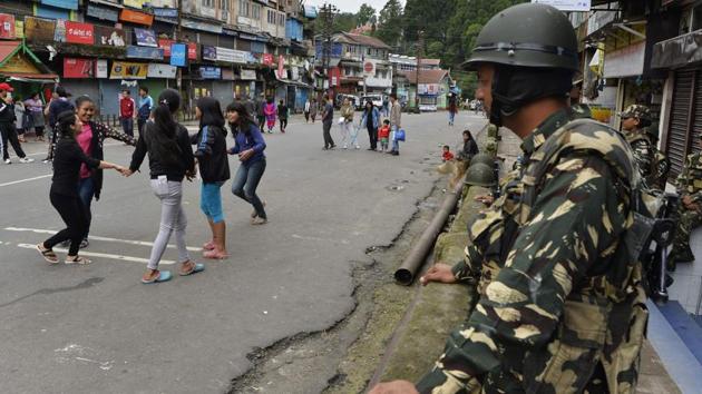 Girls play as paramilitary troops stand guard at Chowkbazar area during an indefinite strike called by Gorkha Janamukti Morcha (GJM) in Darjeeling. (AFP Photo) Girls play as paramilitary troops stand guard at Chowkbazar area during an indefinite strike called by Gorkha Janamukti Morcha (GJM) in Darjeeling. (AFP Photo)