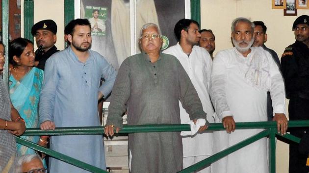 RJD chief Lalu Prasad with party leaders Raghuvansh Prasad Singh and deputy chief minister Tejashwi Yadav after the CBI raids on Friday. (PTI) RJD chief Lalu Prasad with party leaders Raghuvansh Prasad Singh and deputy chief minister Tejashwi Yadav after the CBI raids on Friday. (PTI)