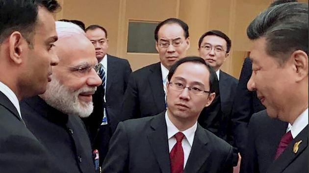Prime Minister Narendra Modi and Chinese President Xi Jinping exchange greetings at the BRICS leaders' informal gathering, in Hamburg, Germany on Friday. (PTI) Prime Minister Narendra Modi and Chinese President Xi Jinping exchange greetings at the BRICS leaders' informal gathering, in Hamburg, Germany on Friday. (PTI)