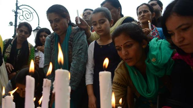 Locals during candle-light march in Shimla on Saturday.(Deepak Sansta/HT Photo)