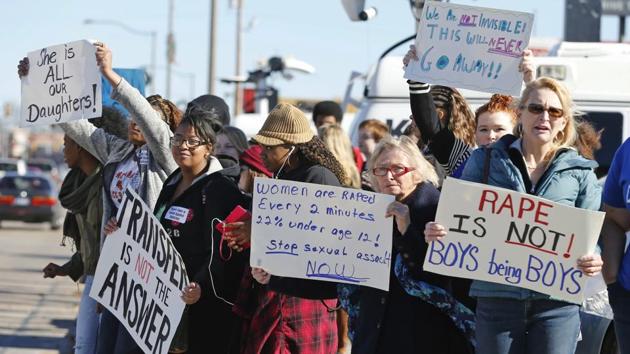 In this Nov. 24, 2014 file photo, students, parents and grandparents hold signs during a protest across the street from Norman High School in Norman, Okla. (AP File Photo) In this Nov. 24, 2014 file photo, students, parents and grandparents hold signs during a protest across the street from Norman High School in Norman, Okla. (AP File Photo)