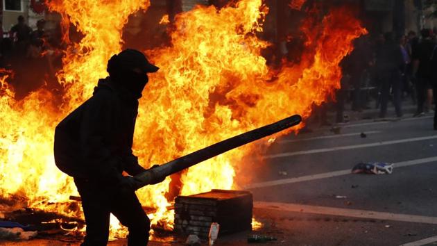 A protester holds a wooden plank during the protests. (REUTERS) A protester holds a wooden plank during the protests. (REUTERS)