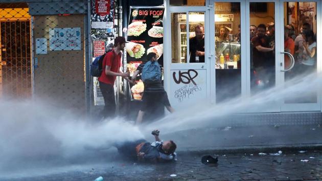 Riot police use water cannon against protesters in Hamburg.Heavily armed police commandos moved in after activists had spent much of the day attempting to wrest control of the streets from more than 15,000 police, setting fires, looting and building barricades. Police said 200 officers had been injured, 134 protesters temporarily detained and another 100 taken into custody. (AFP) Riot police use water cannon against protesters in Hamburg.Heavily armed police commandos moved in after activists had spent much of the day attempting to wrest control of the streets from more than 15,000 police, setting fires, looting and building barricades. Police said 200 officers had been injured, 134 protesters temporarily detained and another 100 taken into custody. (AFP)