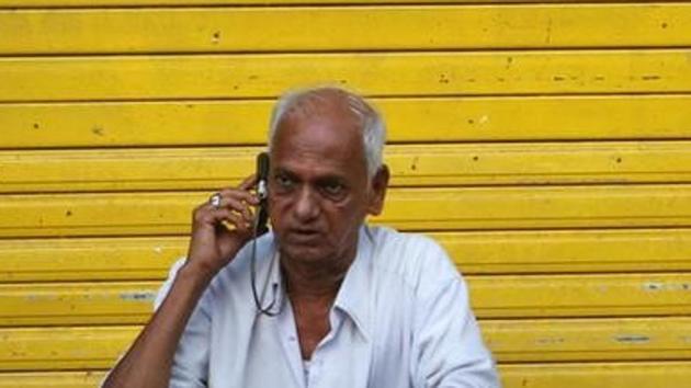 A man speaks on his mobile phone as he sits in front of a shop. (Reuters File Photo) A man speaks on his mobile phone as he sits in front of a shop. (Reuters File Photo)