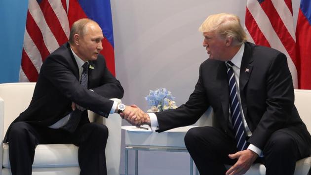 US President Donald Trump (R) and Russia's President Vladimir Putin shake hands as they hold a meeting on the sidelines of the G20 Summit in Hamburg, Germany, on July 7, 2017. Leaders of the world's top economies will gather from July 7 to 8, 2017 in Germany for likely the stormiest G20 summit in years, with disagreements ranging from wars to climate change and global trade. / AFP PHOTO / SPUTNIK / Mikhail KLIMENTIEV (AFP) US President Donald Trump (R) and Russia's President Vladimir Putin shake hands as they hold a meeting on the sidelines of the G20 Summit in Hamburg, Germany, on July 7, 2017. Leaders of the world's top economies will gather from July 7 to 8, 2017 in Germany for likely the stormiest G20 summit in years, with disagreements ranging from wars to climate change and global trade. / AFP PHOTO / SPUTNIK / Mikhail KLIMENTIEV (AFP)