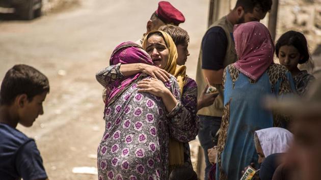 An Iraqi woman, who fled the fighting between government forces and Islamic State (IS) group jihadists in the Old City of Mosul, reacts while embracing another in the city's western industrial district as they wait to be relocated on July 8. (AFP Photo) An Iraqi woman, who fled the fighting between government forces and Islamic State (IS) group jihadists in the Old City of Mosul, reacts while embracing another in the city's western industrial district as they wait to be relocated on July 8. (AFP Photo)
