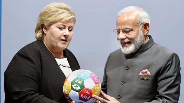 Norway's Prime Minister Erna Solberg presents a symbolic football on sustainable development to Prime Minister Narendra Modi at the G20 Summit, in Hamburg, Germany on Saturday. (PTI photo) Norway's Prime Minister Erna Solberg presents a symbolic football on sustainable development to Prime Minister Narendra Modi at the G20 Summit, in Hamburg, Germany on Saturday. (PTI photo)