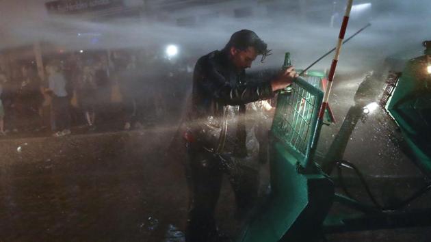 A man takes a ride on a police wrecker in the Schanze district of Hamburg following the G20 summit on July 8, 2017. (Kai Pfaffenbach/REUTERS)