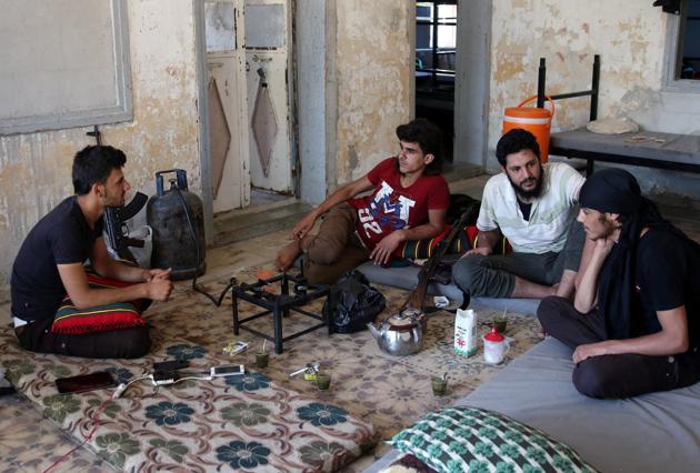Free Syrian Army fighters rest inside a room in Quneitra, Syria on July 8, 2017. (Reuters) Free Syrian Army fighters rest inside a room in Quneitra, Syria on July 8, 2017. (Reuters)