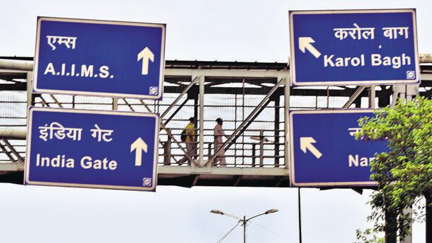 Signboards put up on a foot overbridge in Delhi. Experts say most signage in the city are wrongly placed and have bad design(Vipin Kumar/HT PHOTO)