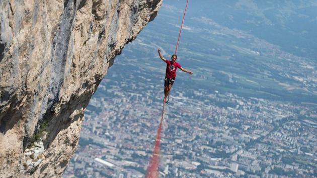 A highliner walks on a slackline during the European "Marmotte Highline Project" meeting on July 7, 2017 in Lans-en-Vercors near Grenoble, eastern France. (AFP)