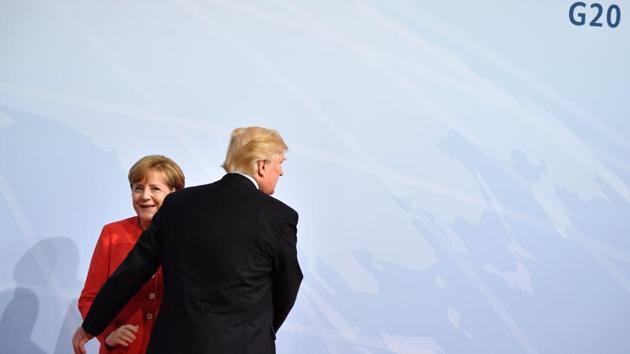 German Chancellor Angela Merkel greets US President Donald Trump at the start of the G20 meeting in Hamburg, northern Germany on July 07, 2017. (John Macdougall/AFP)