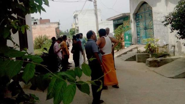 Residents outside the rented house where Sandeep Sharma’s mother and sister-in-law live.(HT Photo)