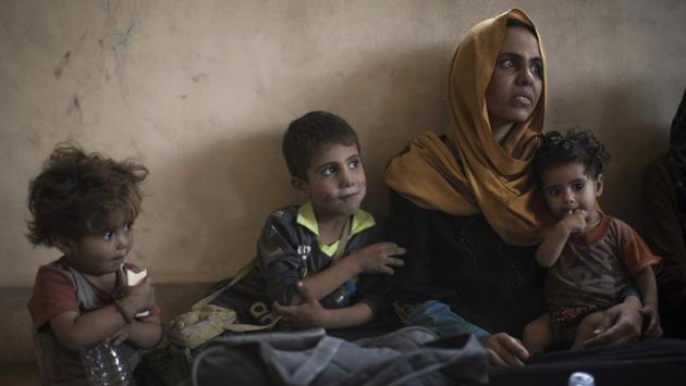 Iraqi civilians sit inside a house as they wait to be taken out of the Old City during fighting between Iraqi forces and Islamic State militants in Mosul, (Felipe Dana / AP) Iraqi civilians sit inside a house as they wait to be taken out of the Old City during fighting between Iraqi forces and Islamic State militants in Mosul, (Felipe Dana / AP)