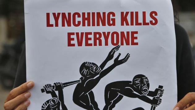 A woman holds a placard during a protest against a spate of violent attacks across the country. (AP File Photo) A woman holds a placard during a protest against a spate of violent attacks across the country. (AP File Photo)